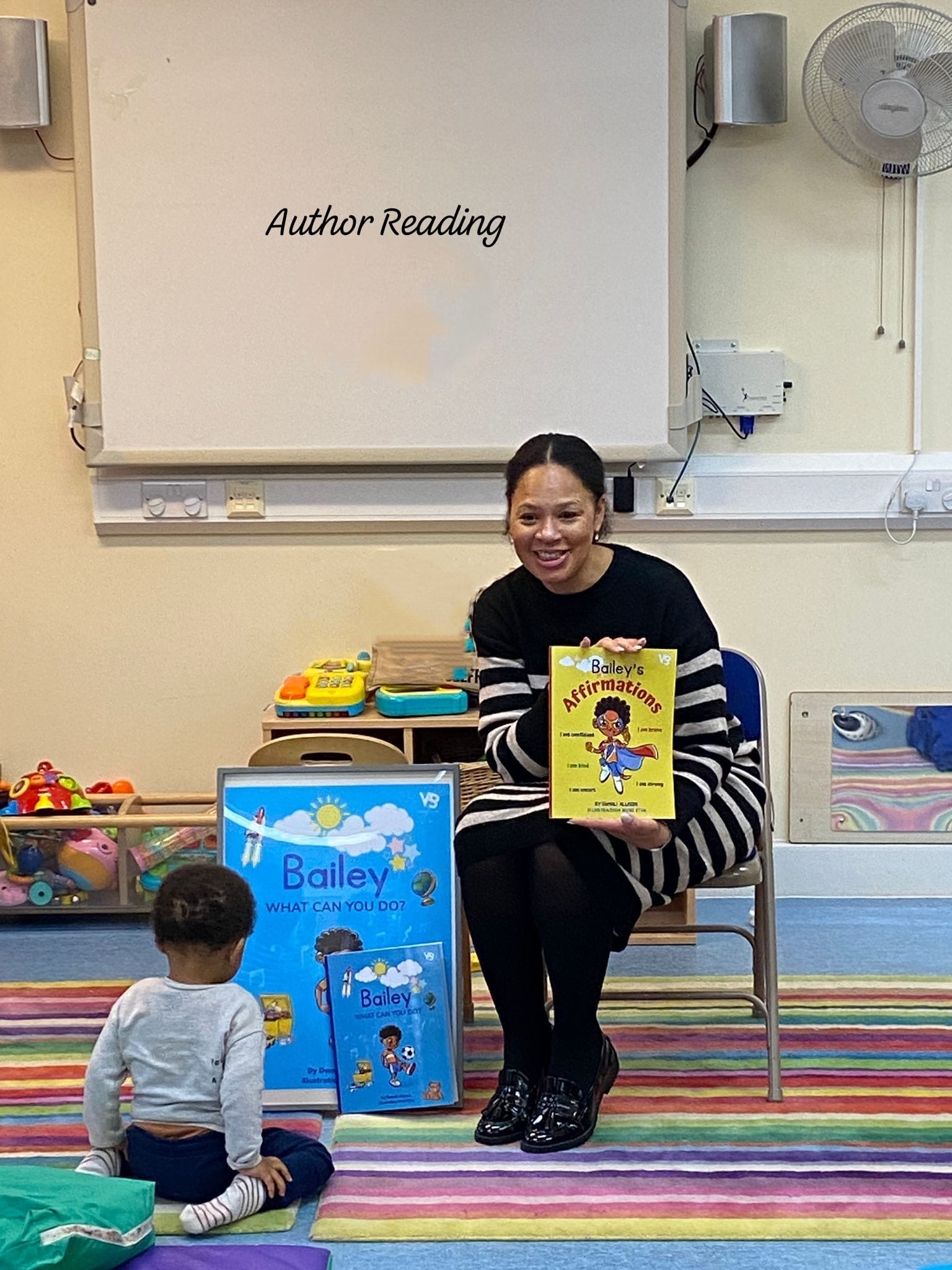 Damali Allison reading to children in a classroom