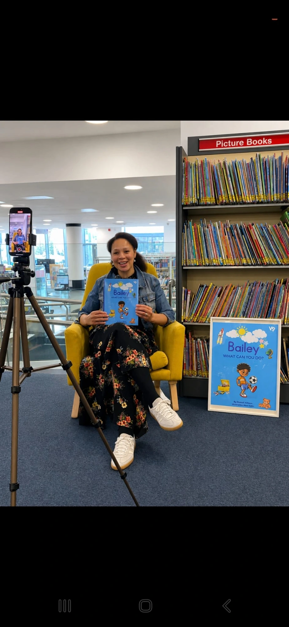 Damali Allison at a library author event, holding Bailey, What Can You Do?